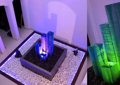 Glass column with light effects on a patio